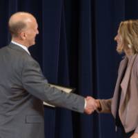 Dean Potteiger shaking hands with a gradute student receiving an award